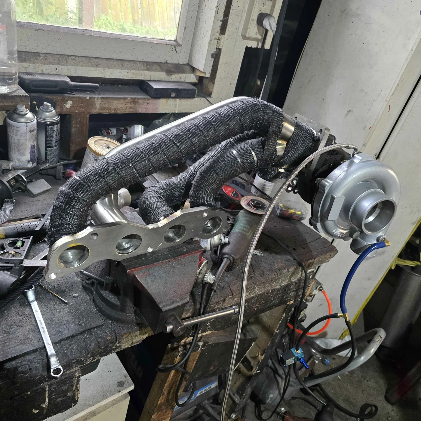 Turbocharger and wrapped manifold on a workshop bench